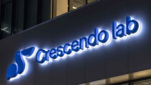 High-quality blue halo-lit backlit metal sign letters 'Crescendo lab' installed on a modern commercial building facade.