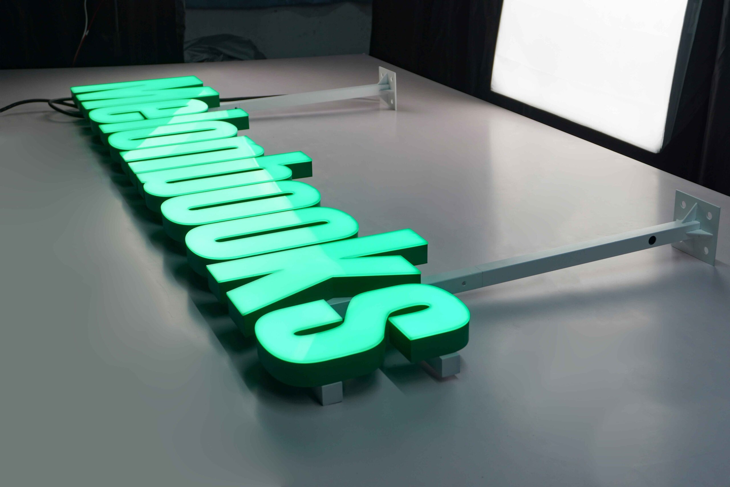  MAJI TREATS brand identity featuring front-lit trimless hanging letters with a silver stainless steel base, creating a premium modern indoor lighting effect.