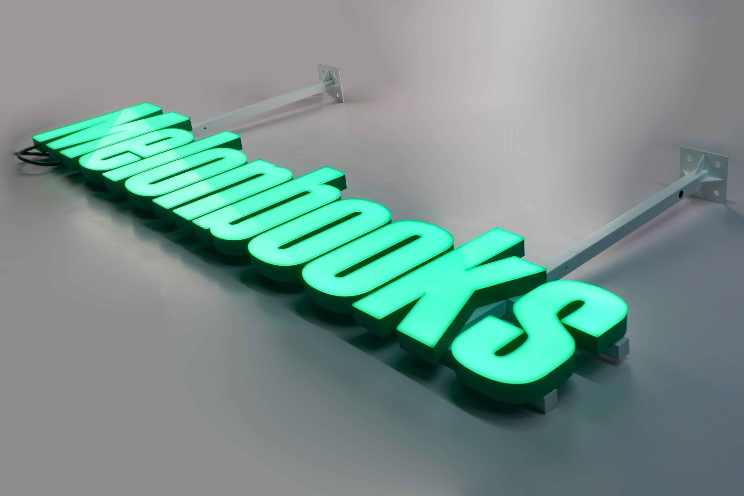  MAJI TREATS brand identity featuring front-lit trimless hanging letters with a silver stainless steel base, creating a premium modern indoor lighting effect.