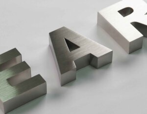 Showcasing 3D metal letters with a fine brushed stainless steel texture, featuring a silky metallic luster and high-precision cutting and polishing craftsmanship.