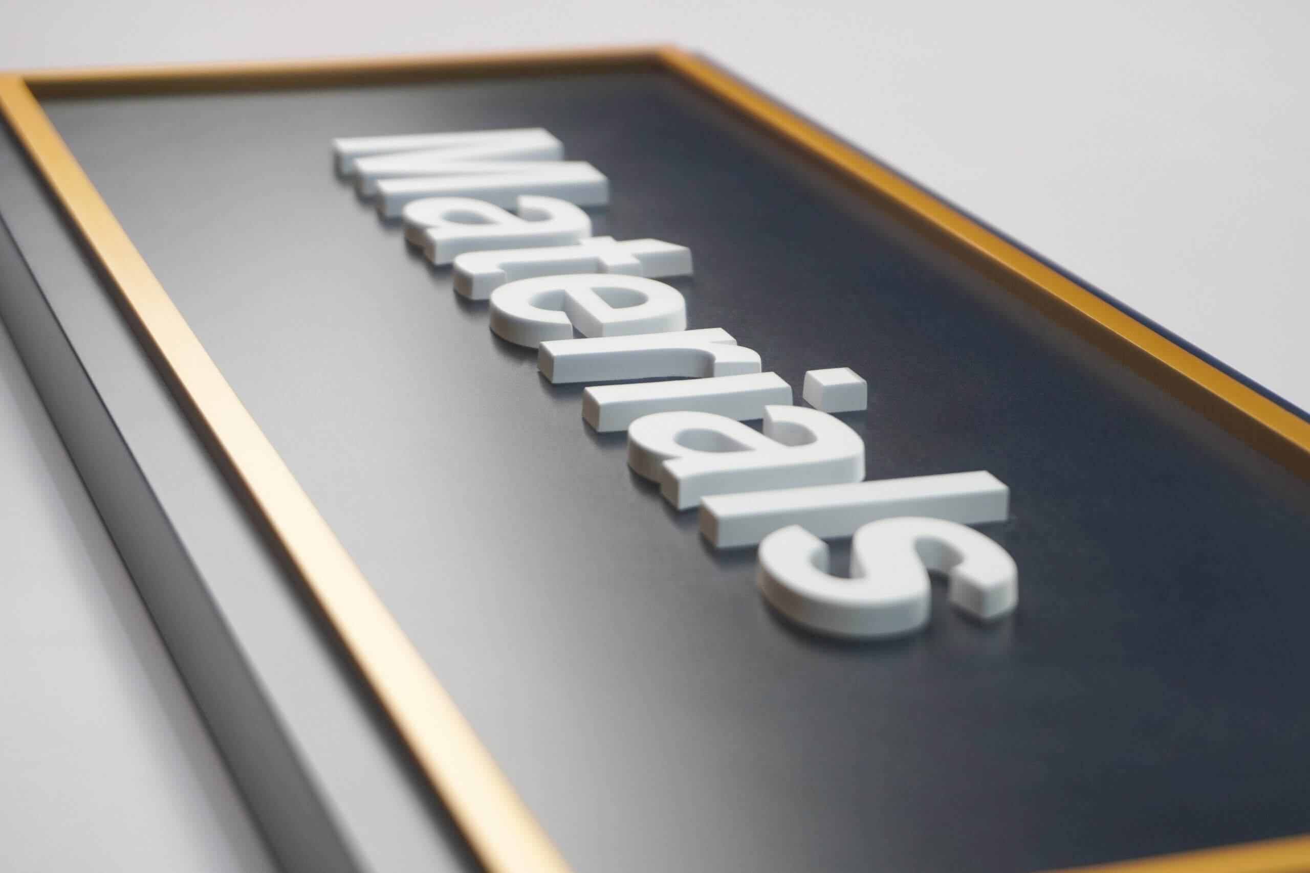 Wayfinding pylon in a corporate building corridor with a blurred figure walking past