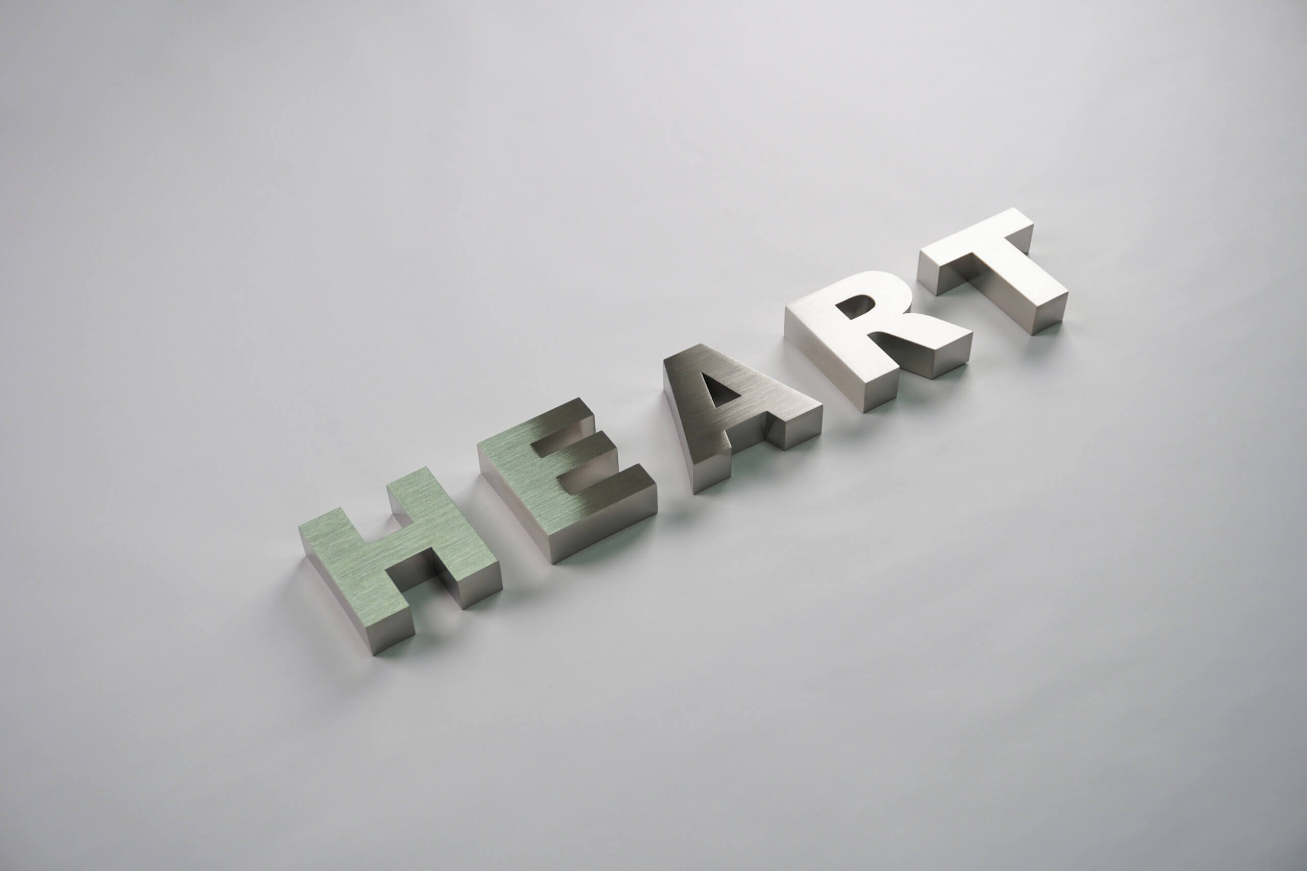 Precision-crafted brushed stainless steel 3D signage letters "HEART", highlighting professional metal fabrication quality.