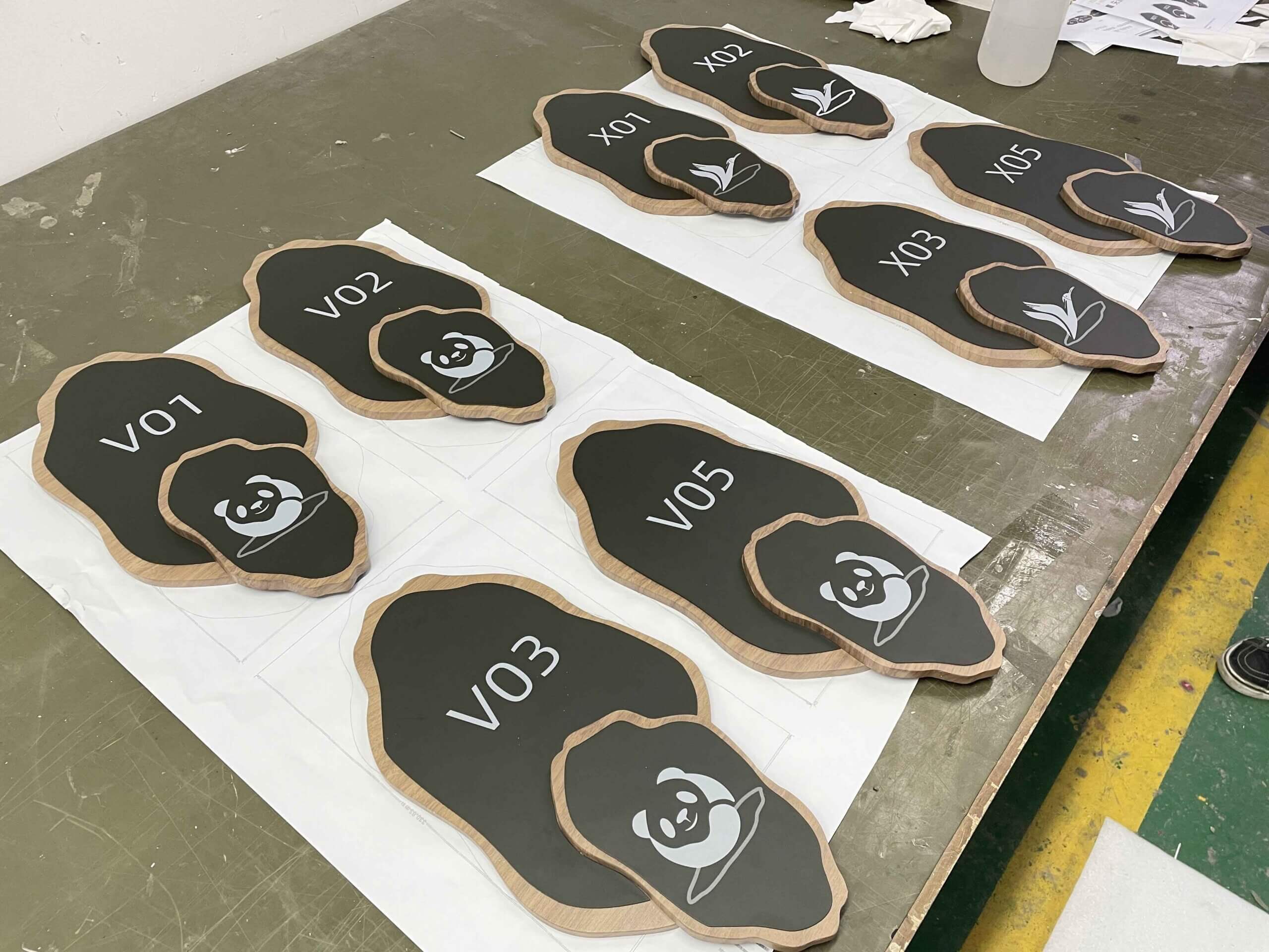 Wayfinding pylon in a corporate building corridor with a blurred figure walking past