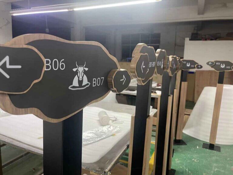 Directional wayfinding signs with cow icon and custom numbers