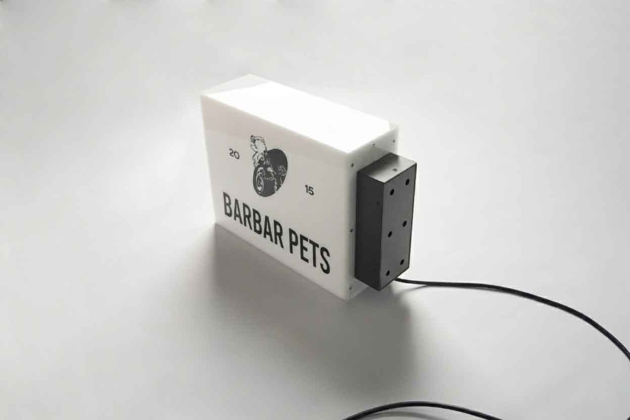 A side-mounted white acrylic light box with 5-sided illumination featuring the "BARBAR PETS" logo and a black wall bracket.
