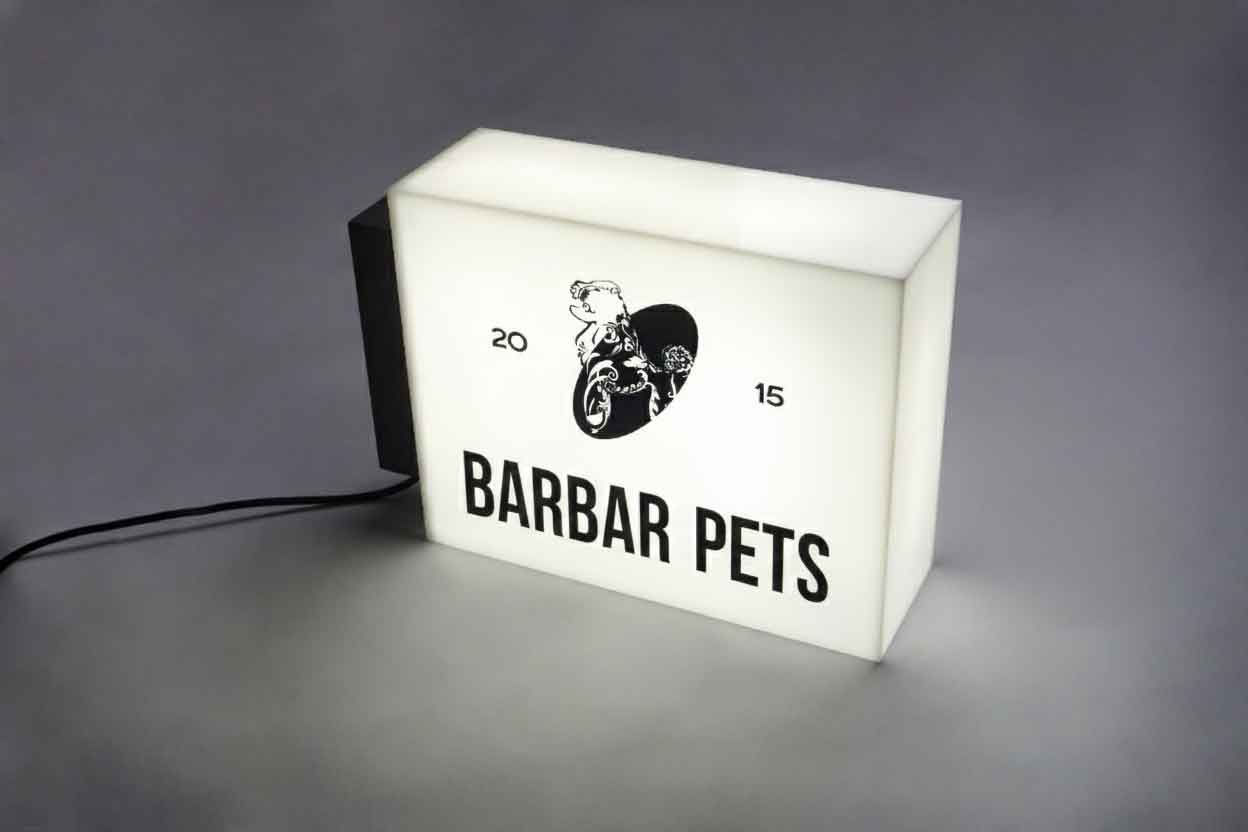 Side view of an illuminated rectangular acrylic box sign with high-brightness LED modules.