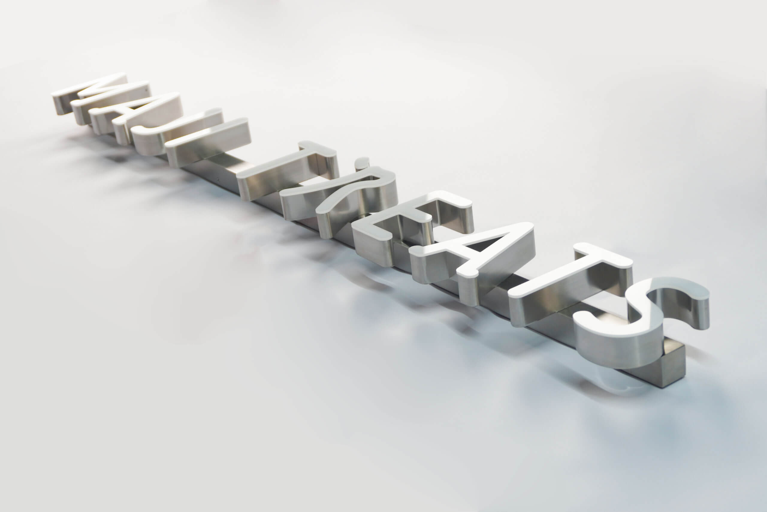  MAJI TREATS brand identity featuring front-lit trimless hanging letters with a silver stainless steel base, creating a premium modern indoor lighting effect.