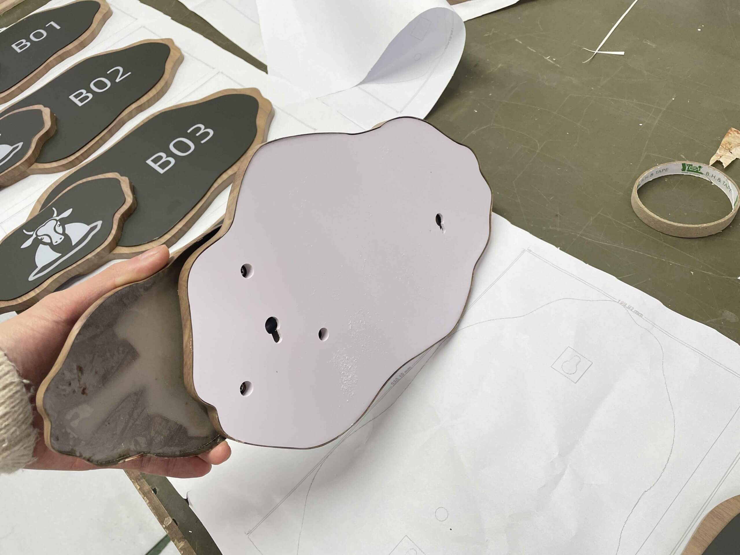 Elegant floor-standing wayfinding pylon in The Dubai Mall, featuring high-contrast bilingual directions and premium metallic finish for luxury retail environments.