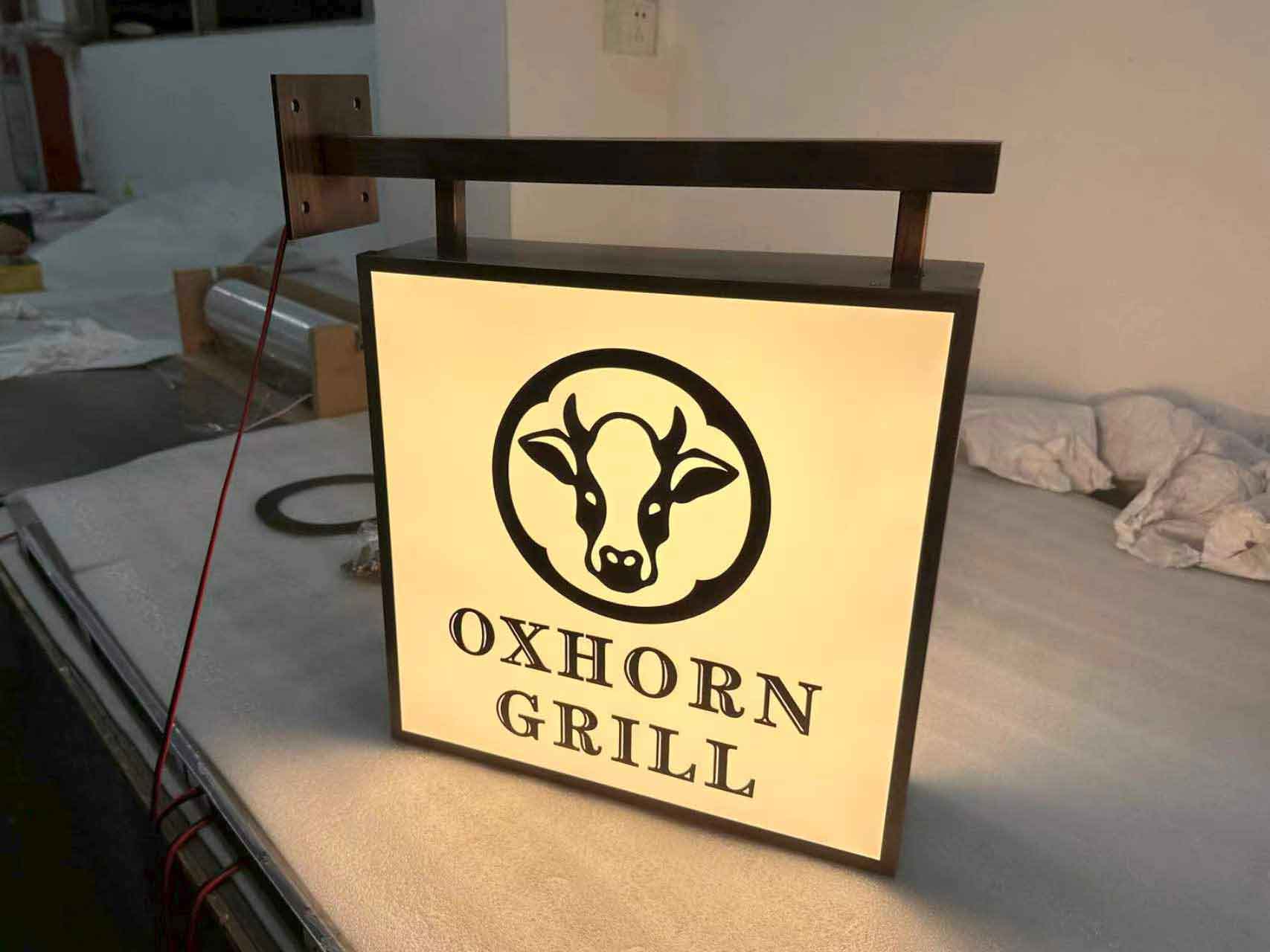 Side view of an illuminated rectangular acrylic box sign with high-brightness LED modules.