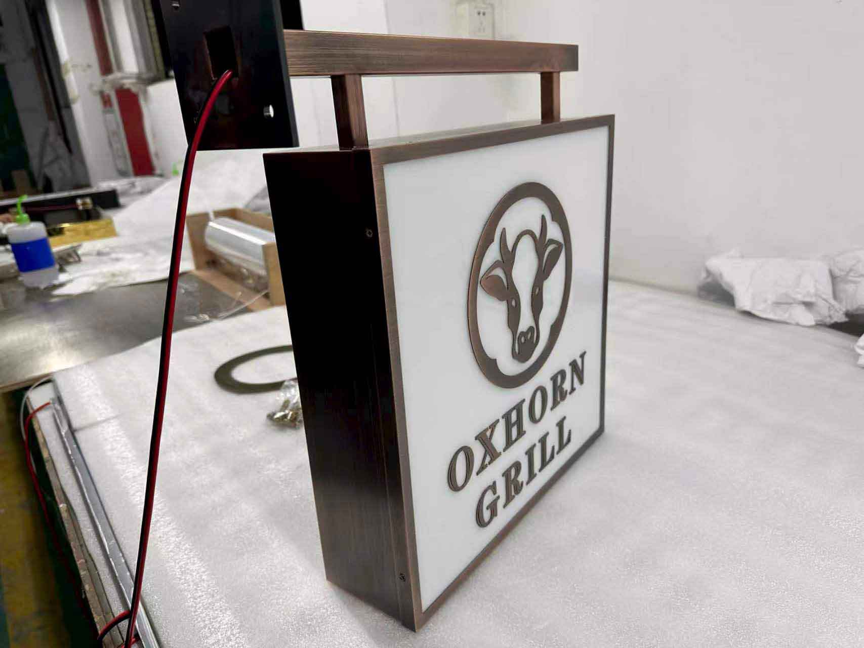 Side view of an illuminated rectangular acrylic box sign with high-brightness LED modules.