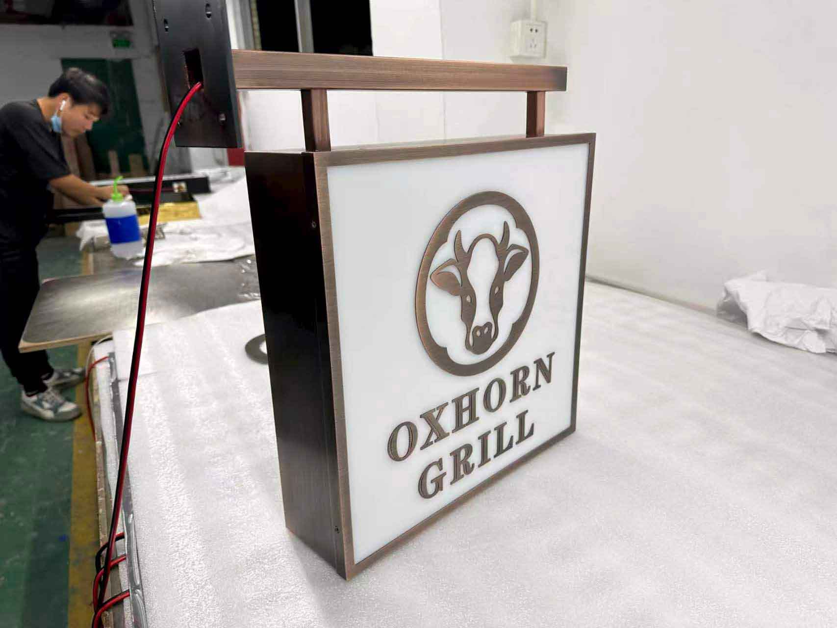 Side view of an illuminated rectangular acrylic box sign with high-brightness LED modules.