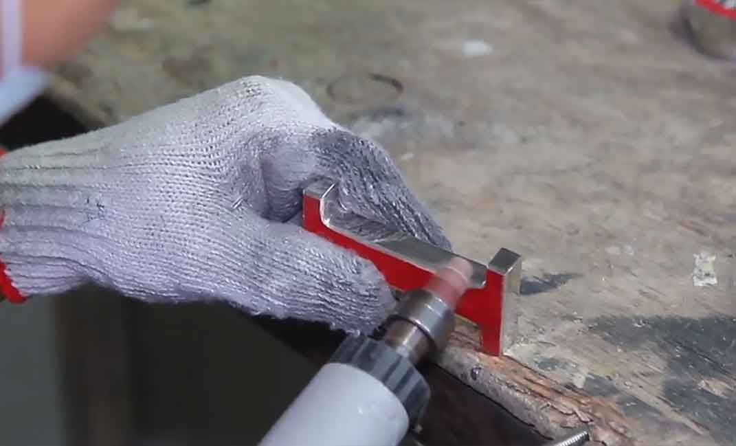 Resources 13 A worker meticulously hand-polishing a solid metal letter to enhance the premium texture of the custom signage